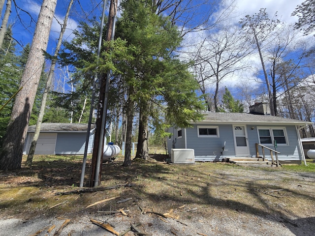 back of property with a chimney and entry steps