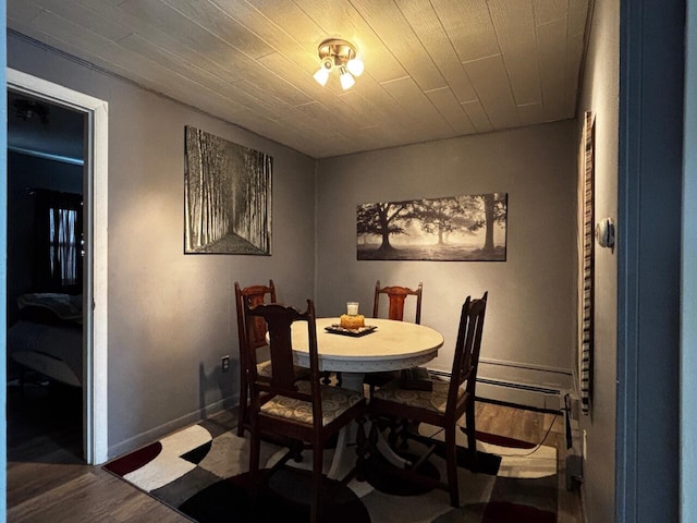dining room featuring baseboards and wood finished floors