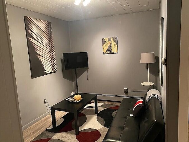 living room with baseboards and wood finished floors