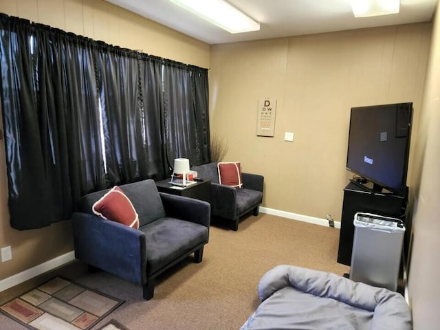 carpeted living room featuring baseboards