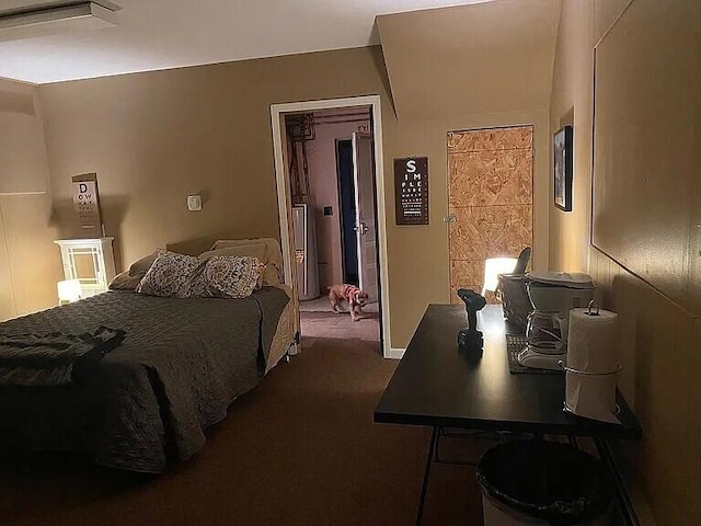 bedroom featuring dark carpet and water heater