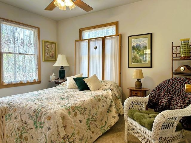 carpeted bedroom with a ceiling fan