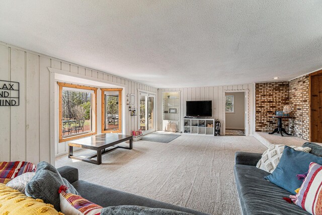 9860 Bingham Rd, Elmira, MI 49730 - living room featuring carpet, wood walls, and a textured ceiling