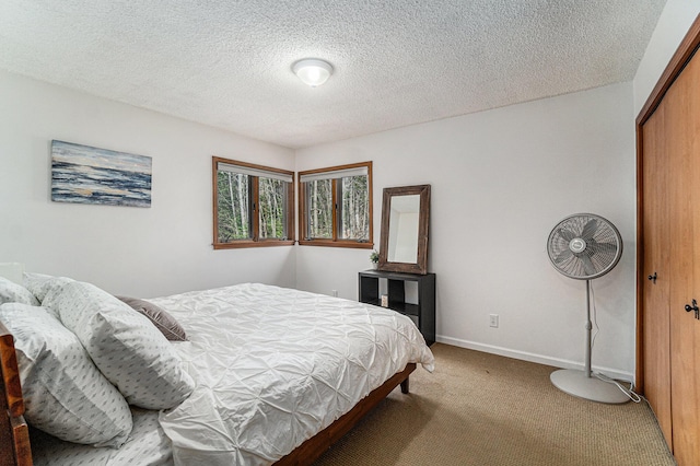 9860 Bingham Rd, Elmira, MI 49730 - carpeted bedroom with a textured ceiling, baseboards, and a closet