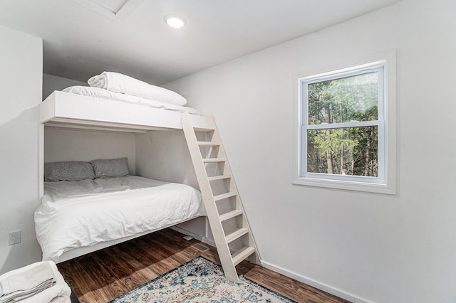 bedroom featuring baseboards, recessed lighting, and wood finished floors