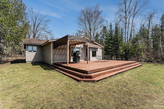 back of property with a lawn and a deck