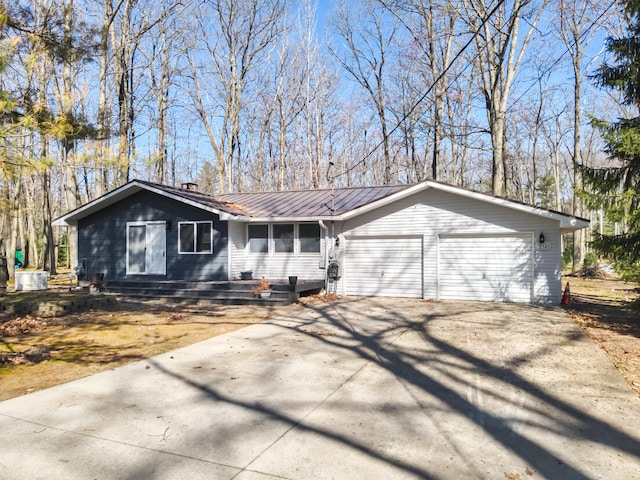 234 Pocahontas Ave, Roscommon, MI 48653 - ranch-style house featuring an attached garage, central AC unit, driveway, and metal roof