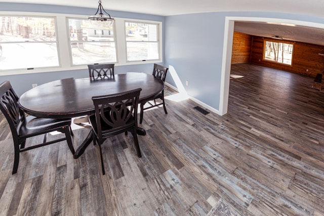 234 Pocahontas Ave, Roscommon, MI 48653 - dining space featuring plenty of natural light, arched walkways, dark wood-type flooring, and visible vents