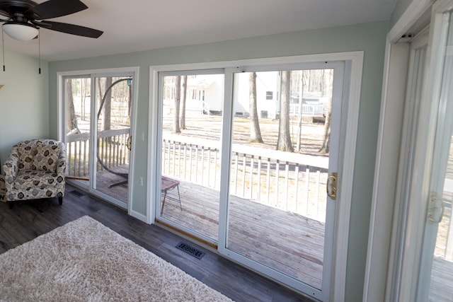 234 Pocahontas Ave, Roscommon, MI 48653 - doorway featuring ceiling fan, visible vents, wood finished floors, and a healthy amount of sunlight