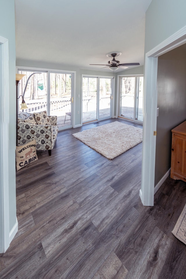 234 Pocahontas Ave, Roscommon, MI 48653 - living area with a ceiling fan, baseboards, and dark wood-type flooring