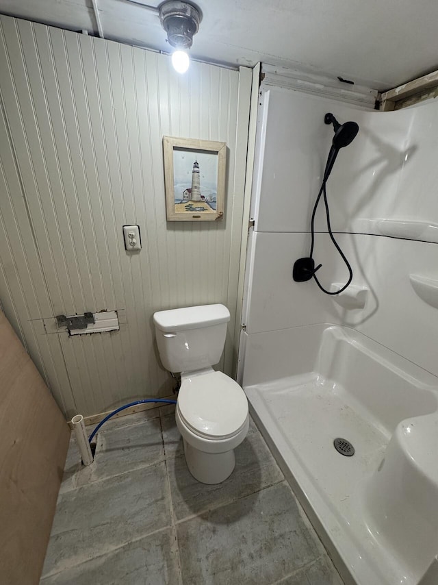 bathroom featuring a stall shower and toilet