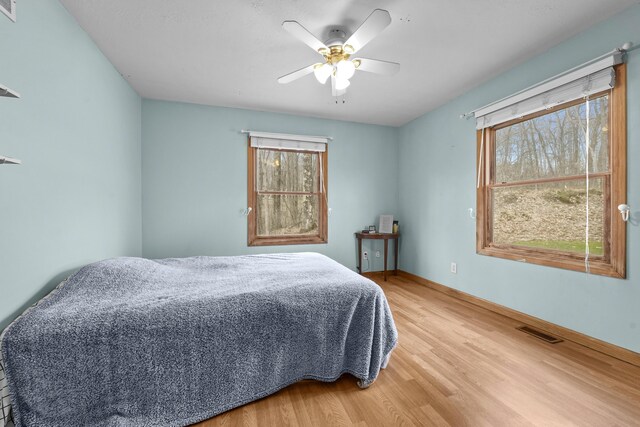 207 Cindy Ave, Roscommon, MI 48653 - bedroom with light wood-style flooring, baseboards, and a ceiling fan