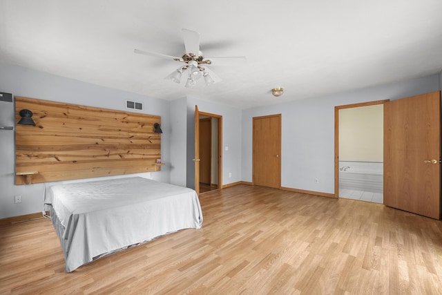207 Cindy Ave, Roscommon, MI 48653 - bedroom featuring light wood-style floors, baseboards, connected bathroom, and ceiling fan