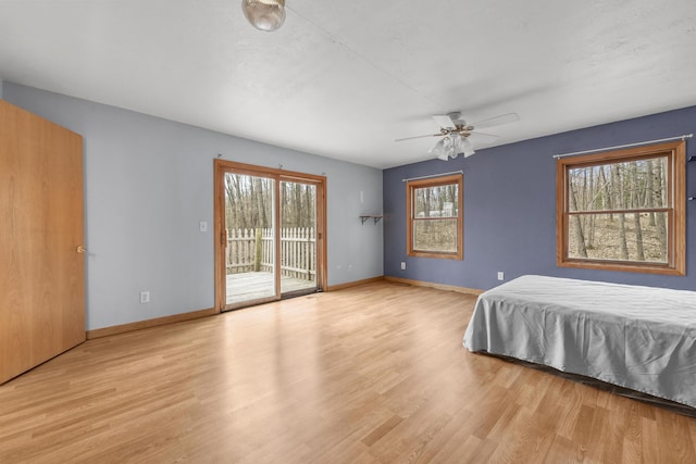 207 Cindy Ave, Roscommon, MI 48653 - bedroom with access to outside, wood finished floors, baseboards, and a ceiling fan