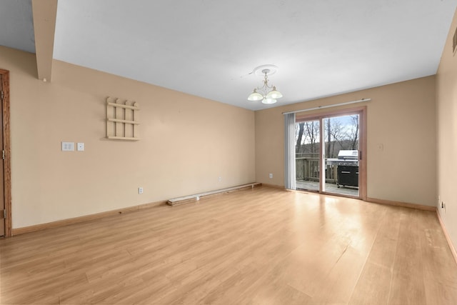 207 Cindy Ave, Roscommon, MI 48653 - empty room with a chandelier, light wood-style flooring, and baseboards