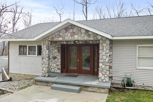 207 Cindy Ave, Roscommon, MI 48653 - view of exterior entry with roof with shingles, french doors, and stone siding