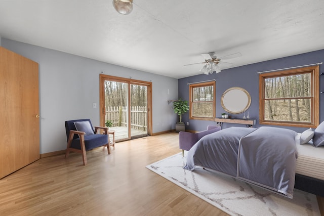 207 Cindy Ave, Roscommon, MI 48653 - bedroom featuring access to outside, wood finished floors, baseboards, and ceiling fan