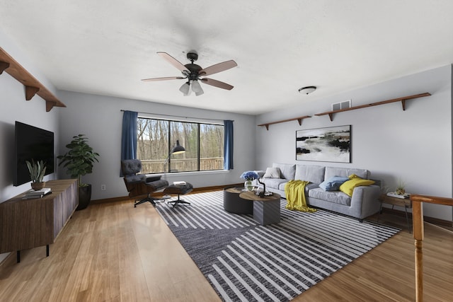 207 Cindy Ave, Roscommon, MI 48653 - living room with light wood finished floors, ceiling fan, and baseboards
