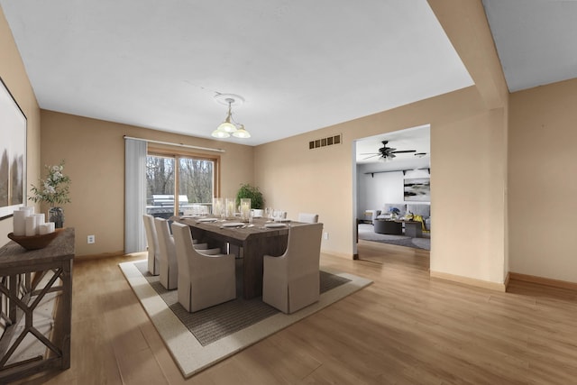 207 Cindy Ave, Roscommon, MI 48653 - dining area featuring light wood-style floors, ceiling fan, and baseboards