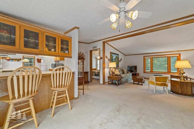 5335 Pinecrest Dr, Lewiston, MI 49756 - dining room featuring carpet floors, a ceiling fan, a textured ceiling, and crown molding