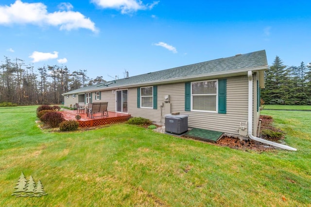 5335 Pinecrest Dr, Lewiston, MI 49756 - back of house featuring central AC unit, roof with shingles, a yard, and a deck