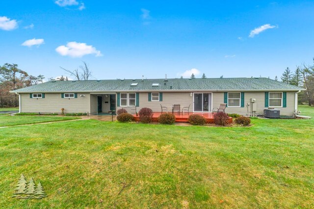 5335 Pinecrest Dr, Lewiston, MI 49756 - back of house featuring a yard, central AC, and a deck