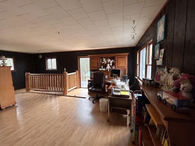 office area with wood walls and light wood finished floors