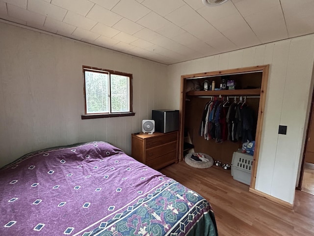 bedroom featuring wood finished floors and a closet