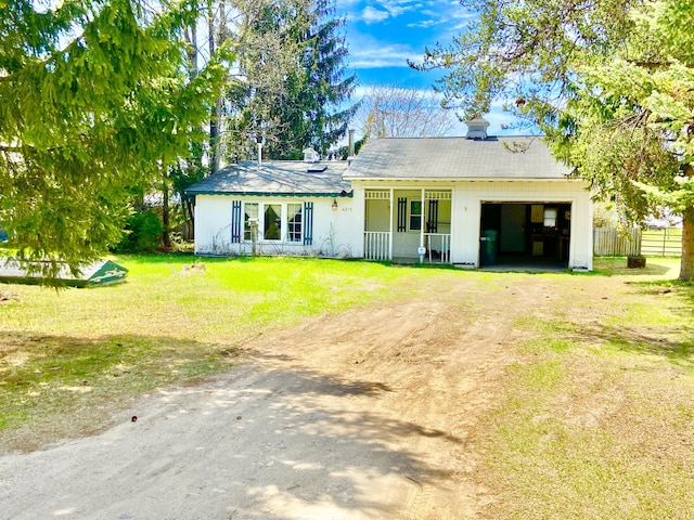 view of front of property with fence, a front lawn, a garage, covered porch, and driveway