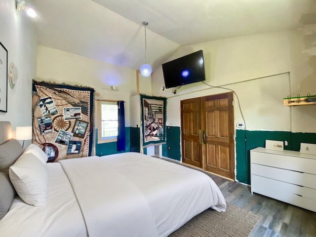 bedroom featuring vaulted ceiling and wood finished floors