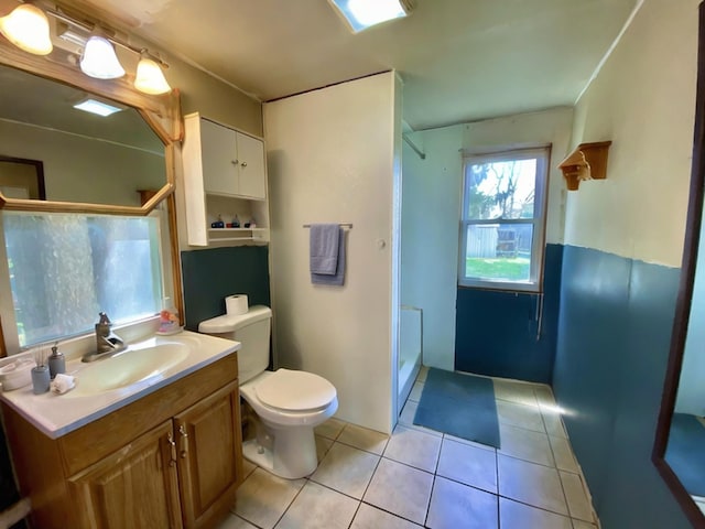 bathroom with vanity, tile patterned floors, a stall shower, and toilet