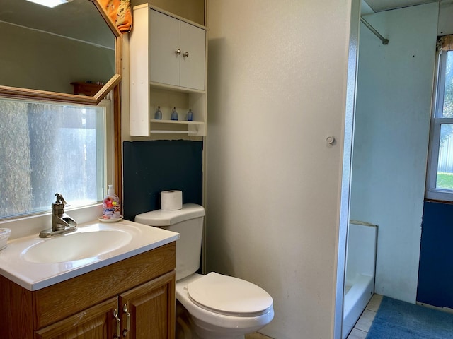 bathroom with vanity, toilet, tile patterned flooring, and a shower