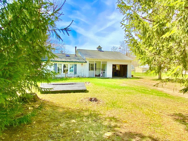rear view of house with a yard