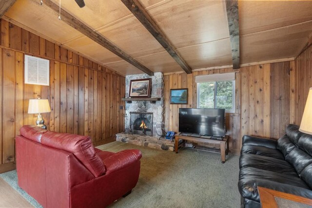15757 Lakeway Dr, Wolverine, MI 49799 - carpeted living area featuring wood ceiling, a stone fireplace, visible vents, wood walls, and beam ceiling
