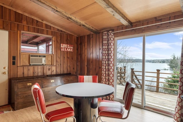 15757 Lakeway Dr, Wolverine, MI 49799 - dining room with wooden walls, a water view, vaulted ceiling with beams, and cooling unit