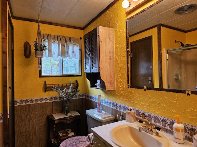 bathroom featuring a stall shower, a textured wall, and visible vents