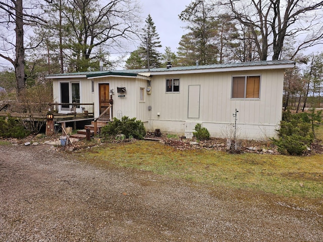 manufactured / mobile home with metal roof and a wooden deck