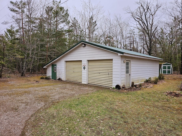 detached garage featuring a shed