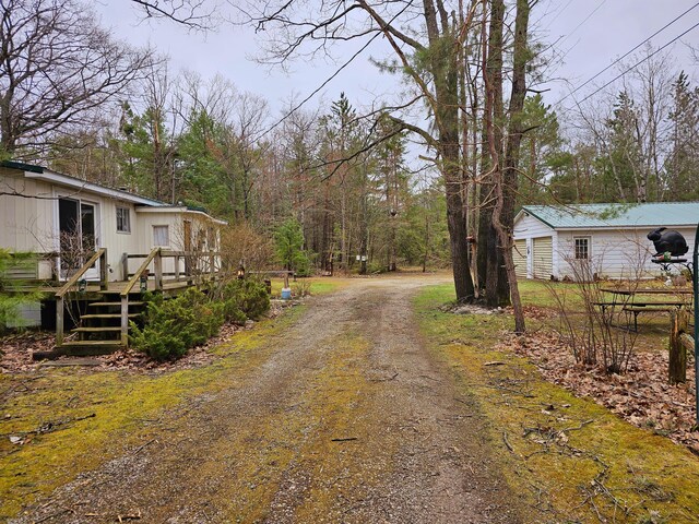 view of road featuring dirt driveway