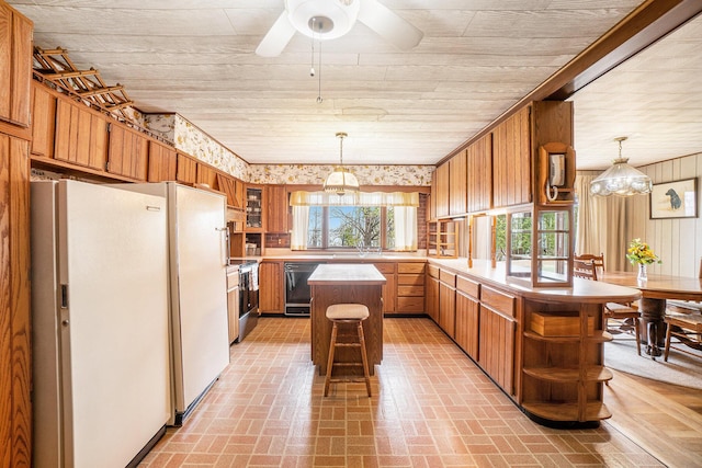 3659 N Straits Hwy, Cheboygan, MI 49721 - kitchen with black dishwasher, freestanding refrigerator, a peninsula, open shelves, and brick patterned flooring