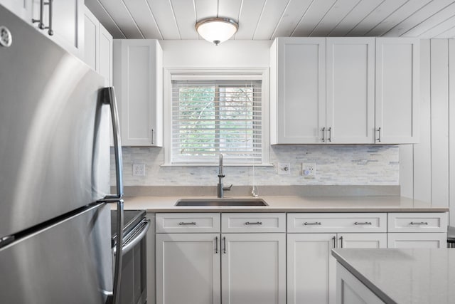 5012 Green Acre Dr, Frederic, MI 49733 - kitchen with freestanding refrigerator, a sink, wooden ceiling, electric range oven, and white cabinetry