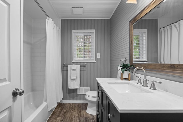 5012 Green Acre Dr, Frederic, MI 49733 - full bathroom with wood finished floors, toilet, vanity, baseboards, and shower / tub combo