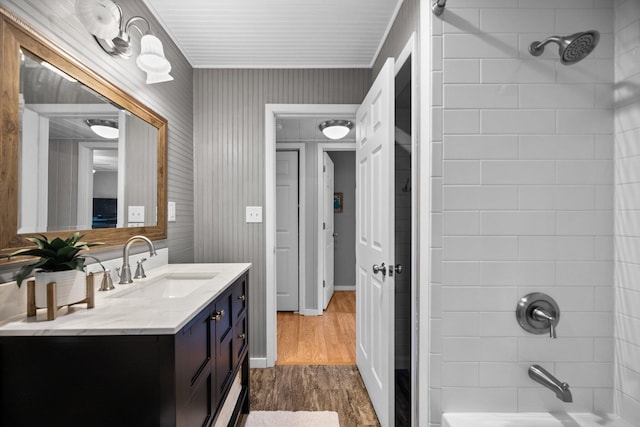 5012 Green Acre Dr, Frederic, MI 49733 - full bathroom with wood finished floors, vanity, and shower / tub combination