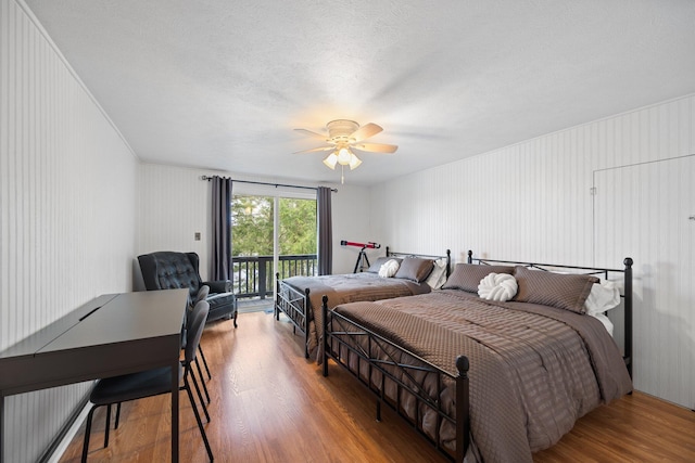 5012 Green Acre Dr, Frederic, MI 49733 - bedroom featuring access to outside, wood finished floors, and a ceiling fan