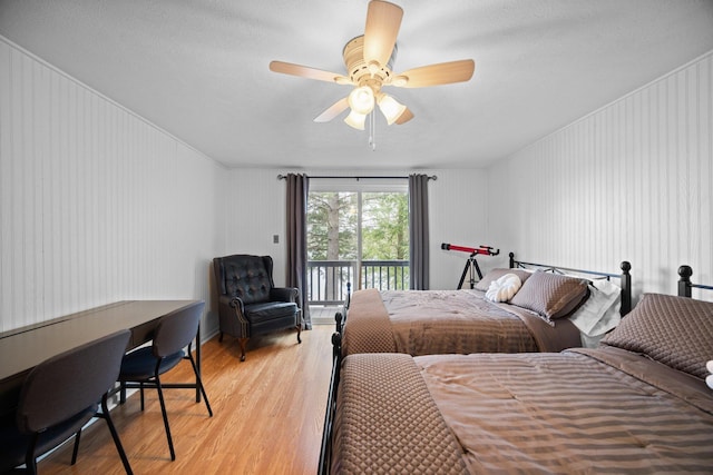 5012 Green Acre Dr, Frederic, MI 49733 - bedroom featuring access to exterior, light wood-style flooring, and a ceiling fan