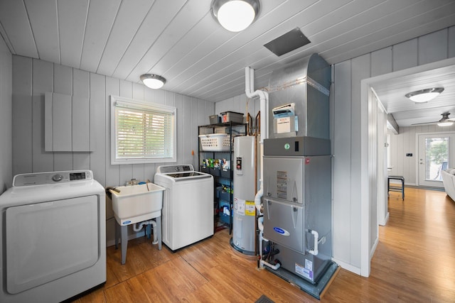 5012 Green Acre Dr, Frederic, MI 49733 - washroom with electric water heater, independent washer and dryer, light wood-style floors, and heating unit