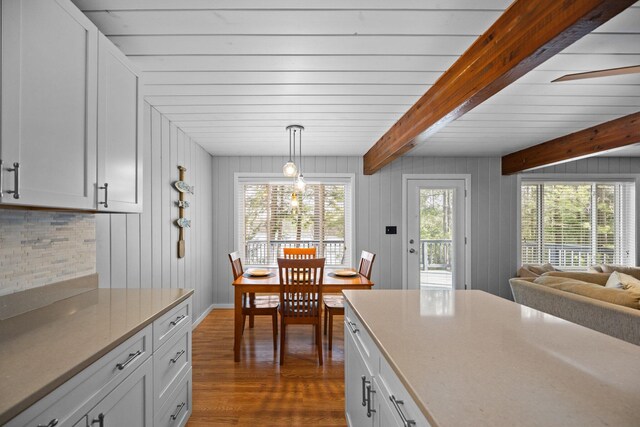 5012 Green Acre Dr, Frederic, MI 49733 - kitchen featuring dark wood-style flooring, decorative backsplash, beam ceiling, white cabinetry, and light countertops