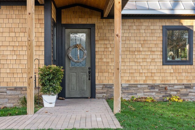 835 M-88, Bellaire, MI 49615 - entrance to property featuring a standing seam roof, stone siding, and metal roof