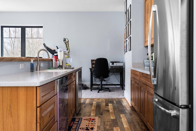 835 M-88, Bellaire, MI 49615 - kitchen with stainless steel appliances, a sink, dark wood finished floors, and brown cabinets