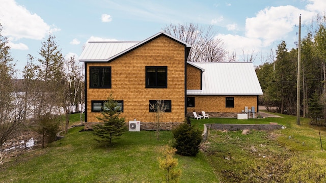 835 M-88, Bellaire, MI 49615 - rear view of house featuring a yard, metal roof, and a cooling unit